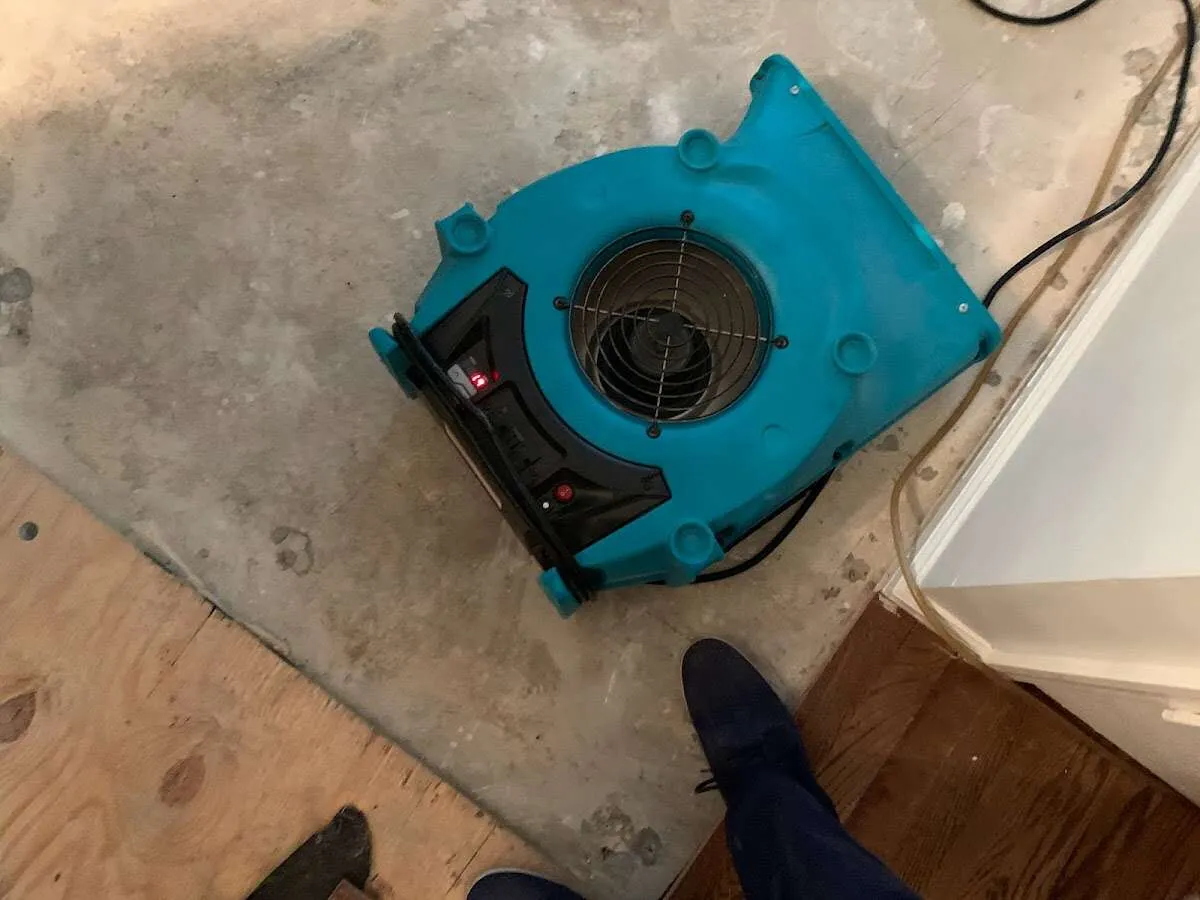 Air mover drying subfloor during Commercial Water Damage Restoration in Fairburn